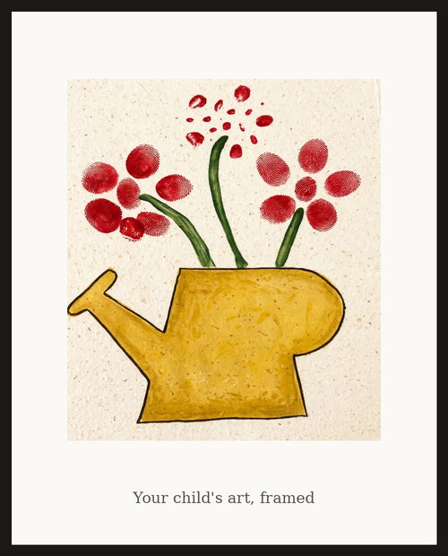 Framed watering can artwork on a wall